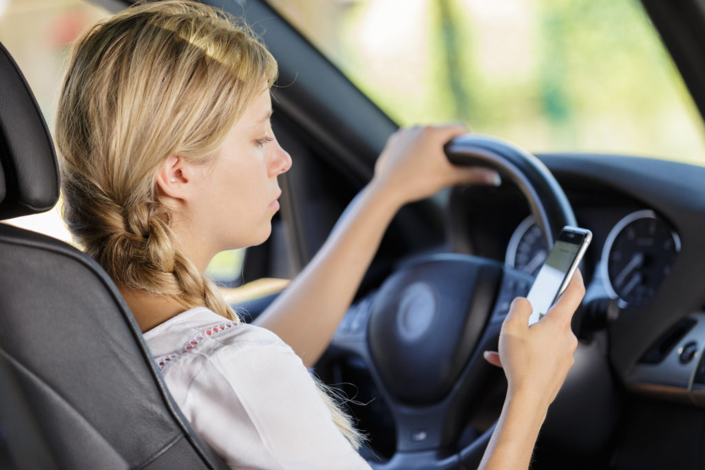 woman distractedly driving automatic transmission car