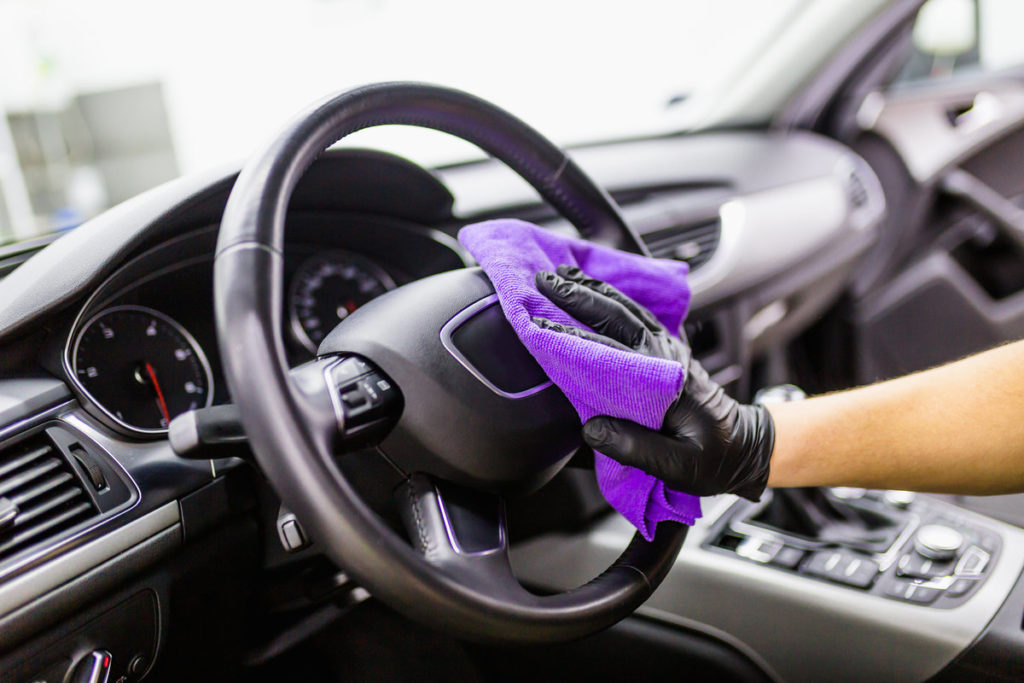 cleaning the steering wheel of a car