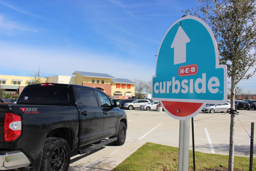 truck stopping at HEB curbside pickup sign
