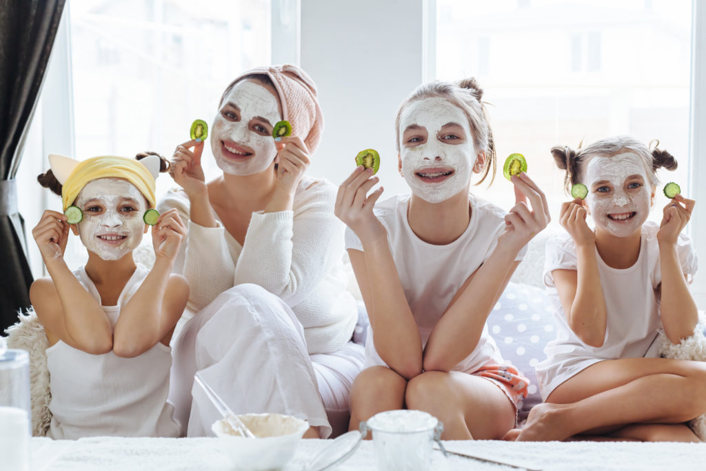 Mom and daughters having a home spa day with clay masks