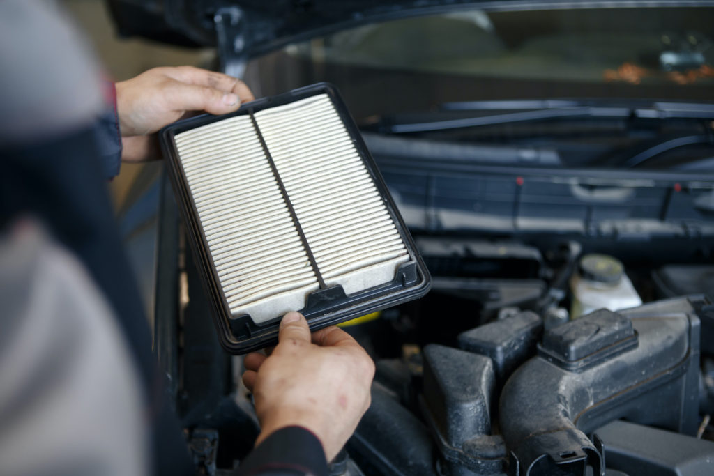 mechanic holding an air filter