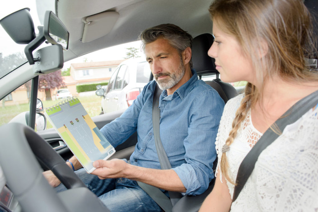 teen girl taking driving test with DMV instructor
