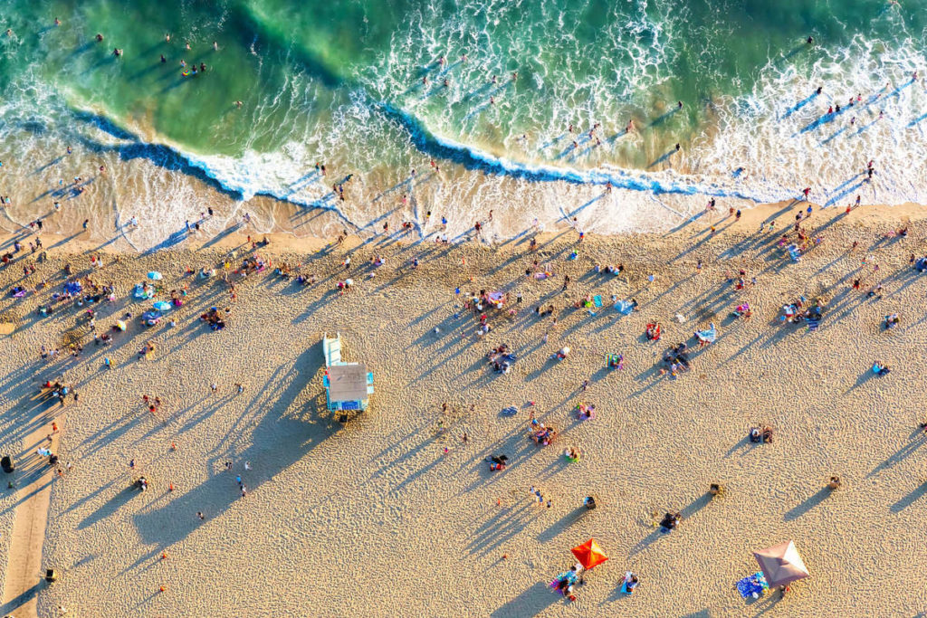 people social distancing at the beach