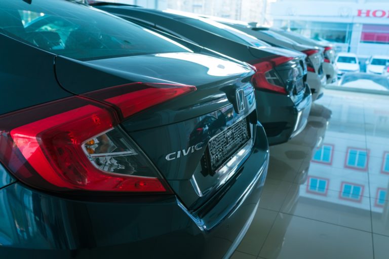 honda civic cars lined up in showroom