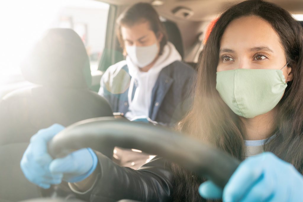 rideshare driver and passenger wearing masks
