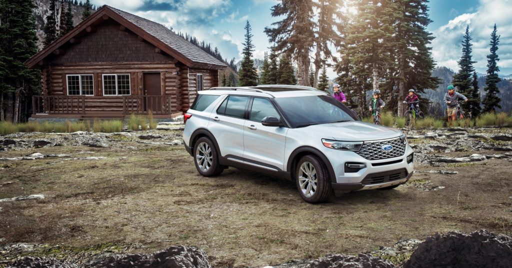 2021 Ford Explorer parked beside a house in the woods
