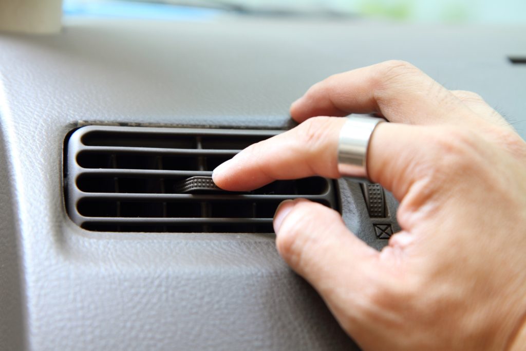 Man adjusting car's A/C