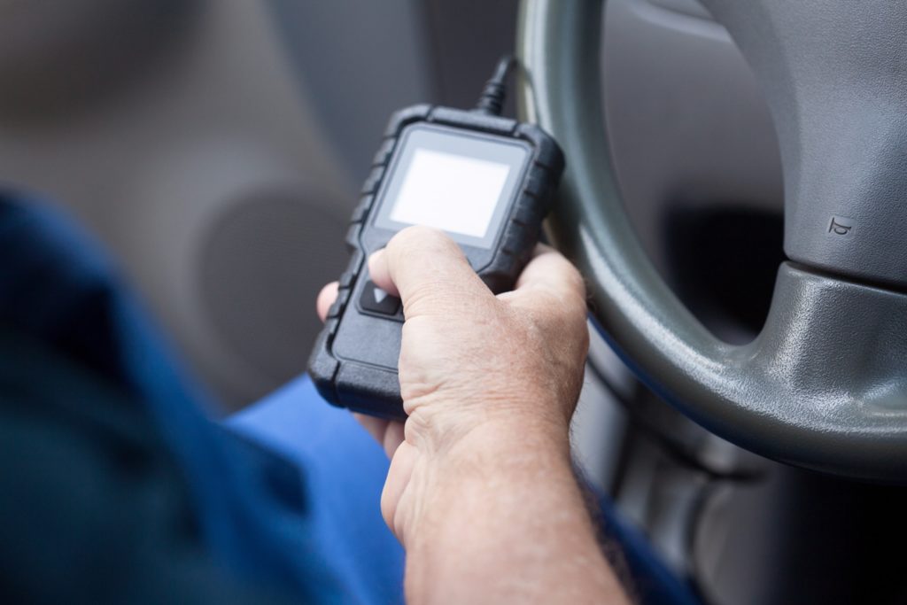 Mechanic using car diagnostic scan tool