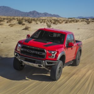 ford f 150 raptor on dusty path
