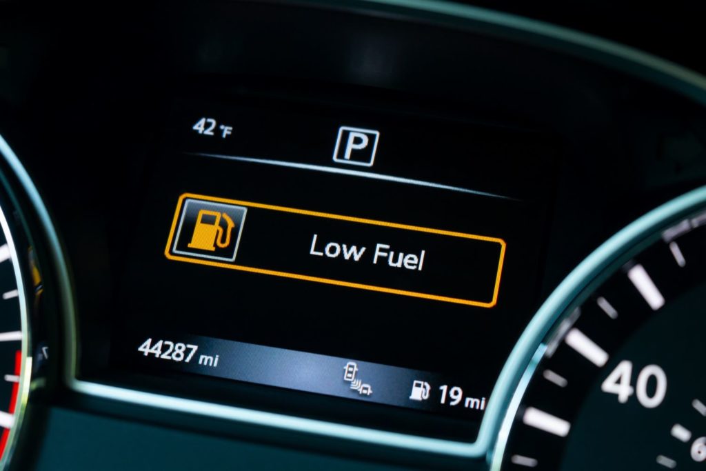 low fuel indicator on car dashboard