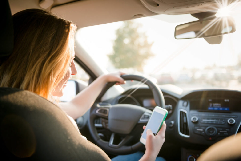 teen girl texting while driving
