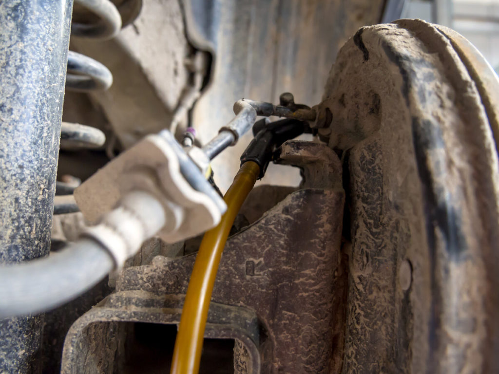 hose connected to brake for bleeding brakes