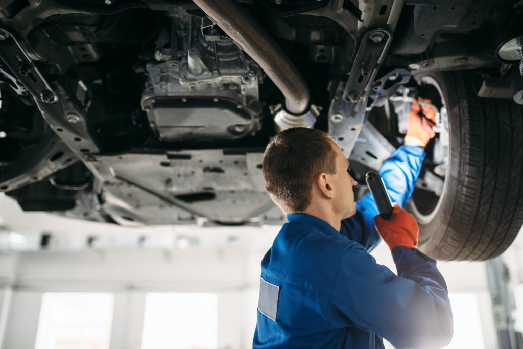 mechanic checking brake hose