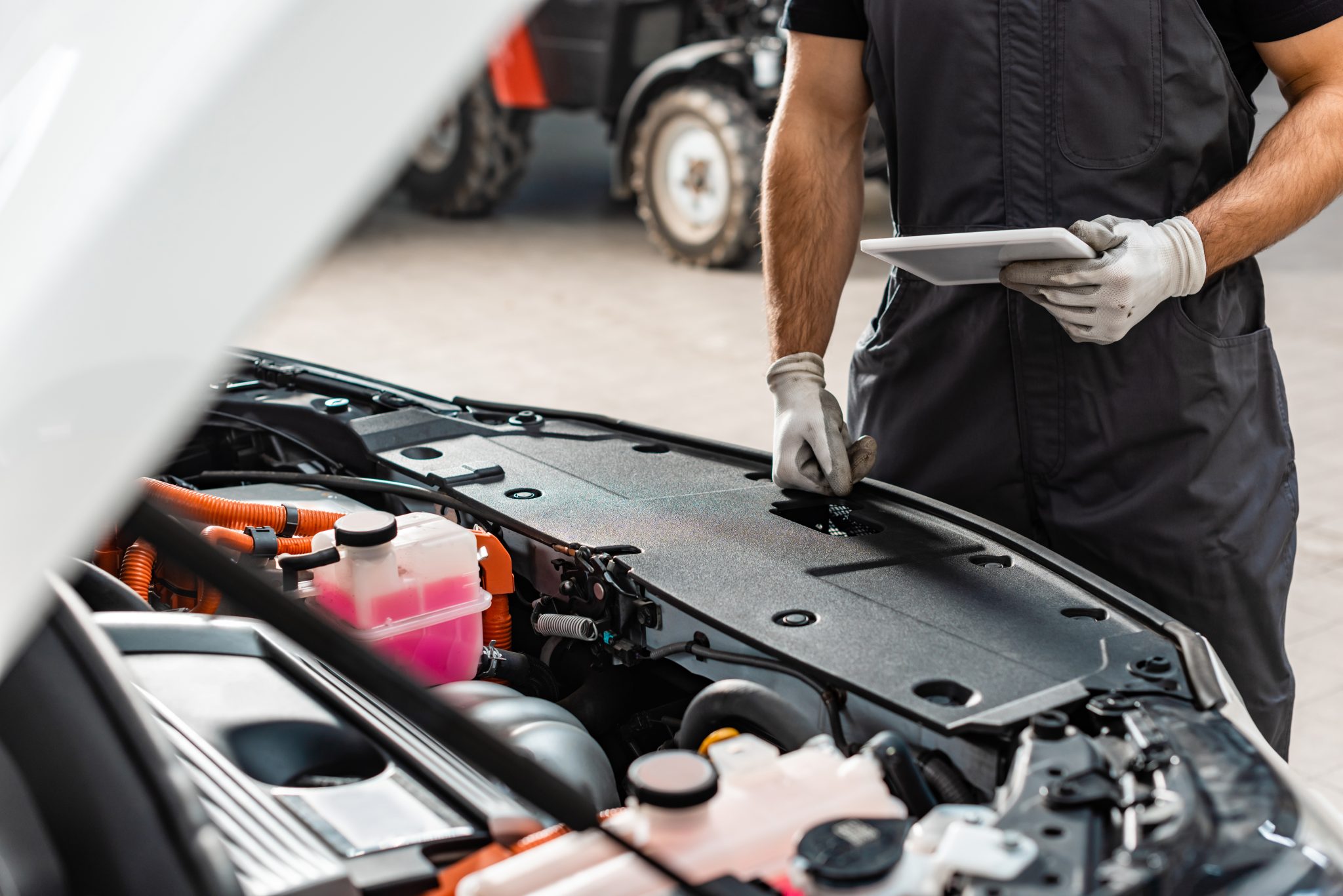 mechanic checking car using a tablet
