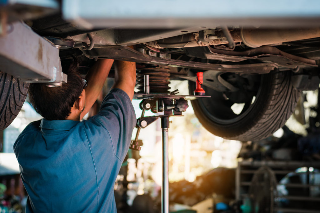 mechanic checking the suspension system