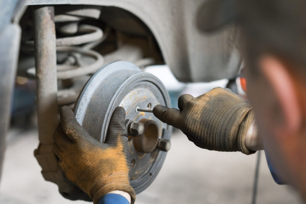 mechanic checking brake drum