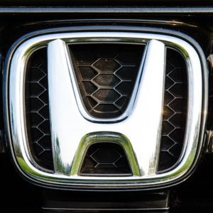 closeup of honda logo on car grille