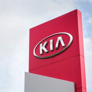 kia logo on dealership building against the sky