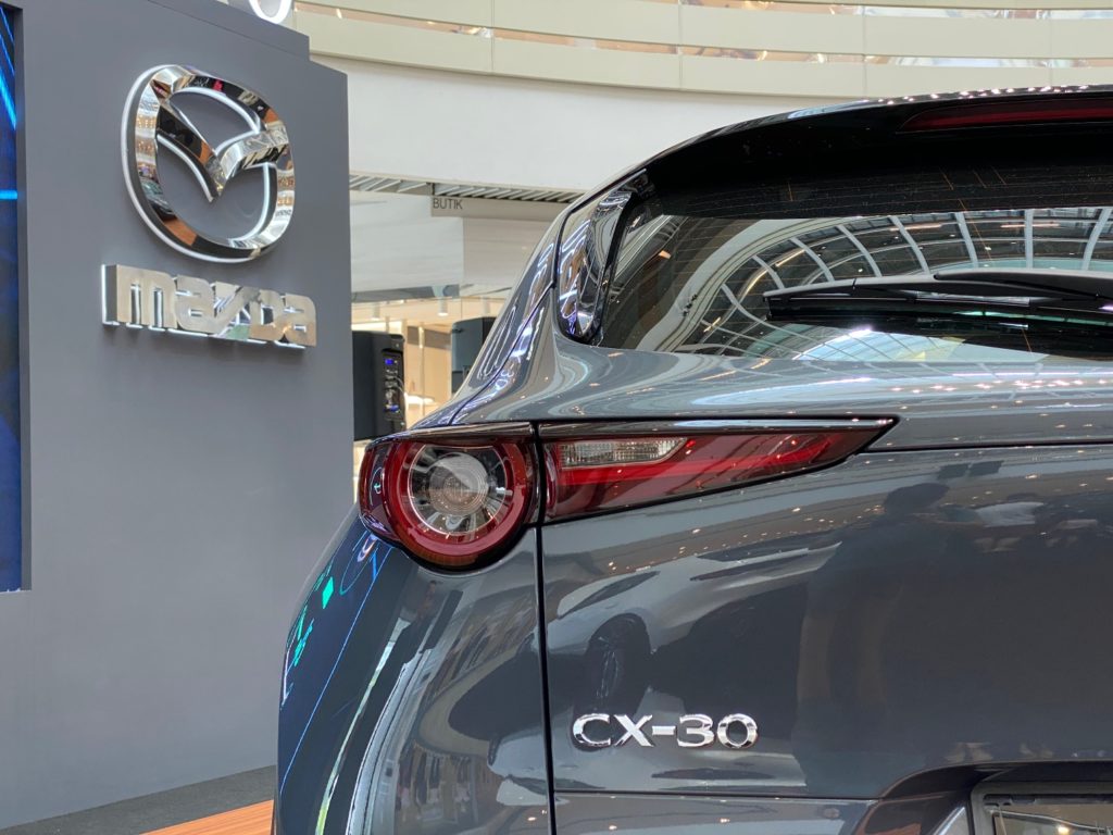 rear shot of cx 30 beside mazda logo
