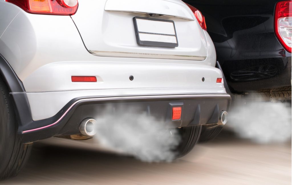 combustion fumes coming out of car exhaust pipe