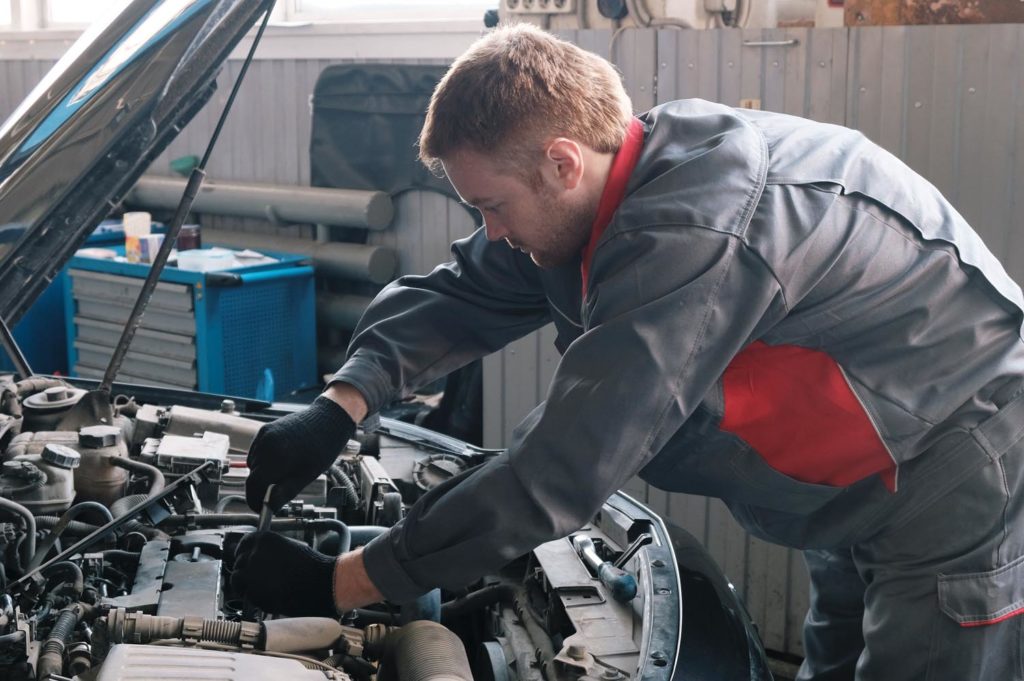 mechanic performs work on replacing the ignition module