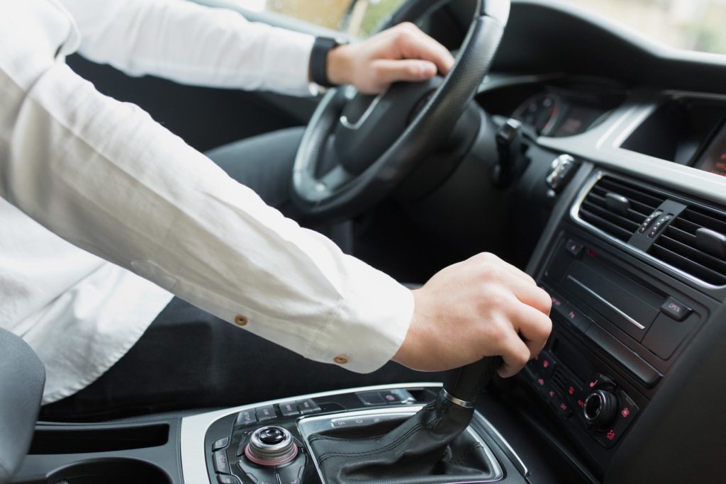 person holding automatic transmission gear stick