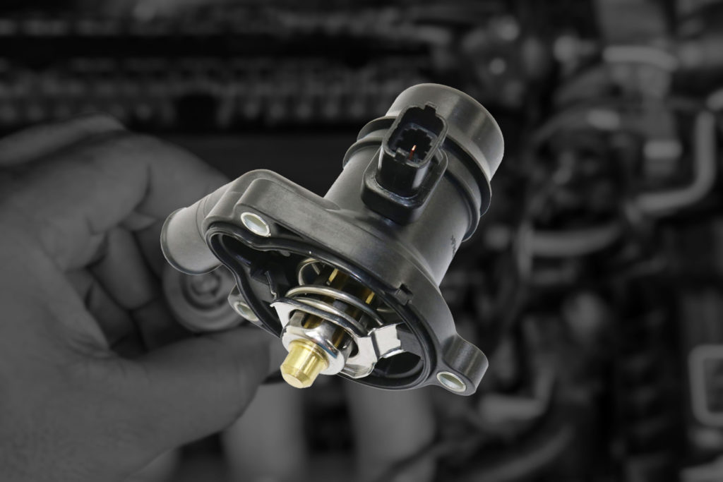 Thermostat Housing Leak Causes, Replacement Cost, Symptoms In The