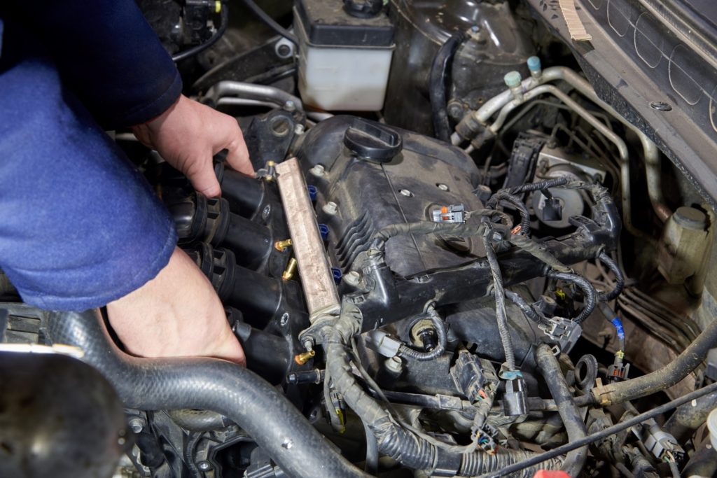 mechanic checking vacuum leak