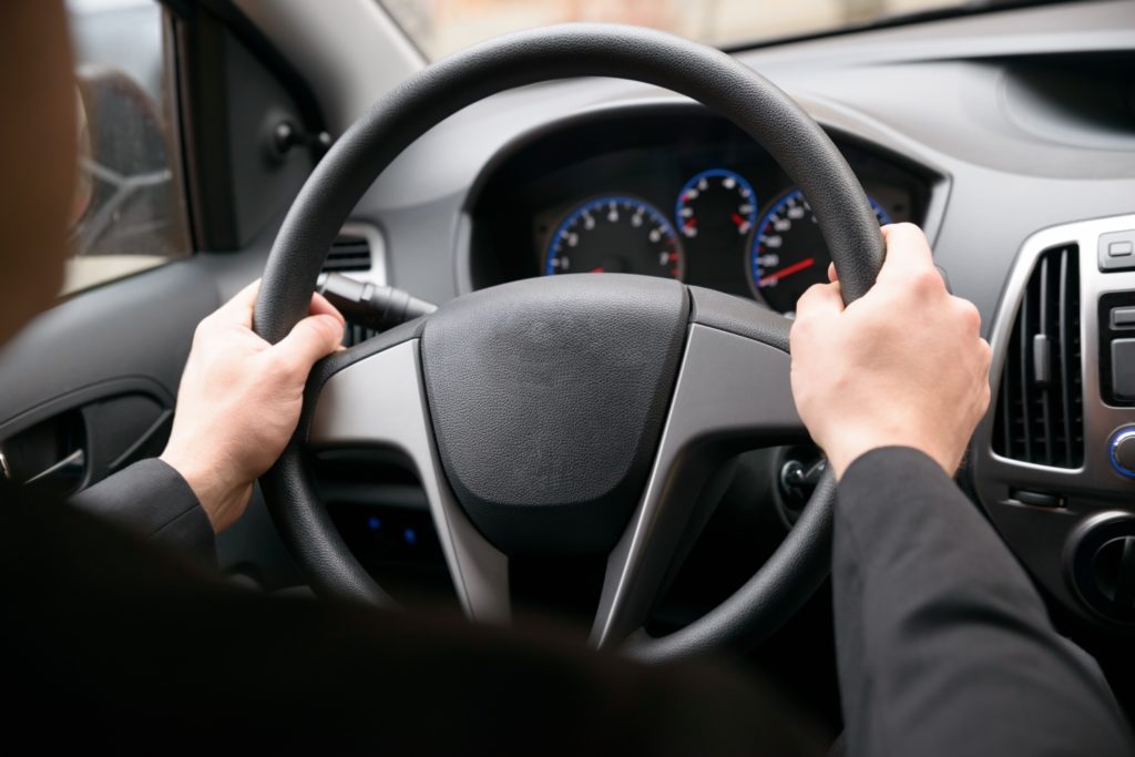 driver holding steering wheel