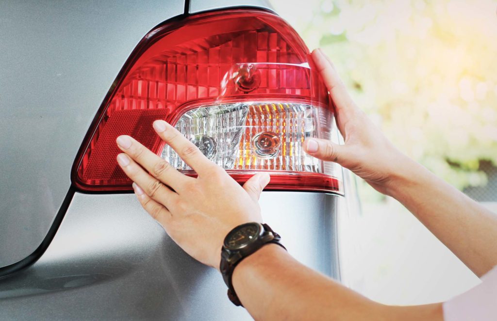 man checking his rear light before traveling