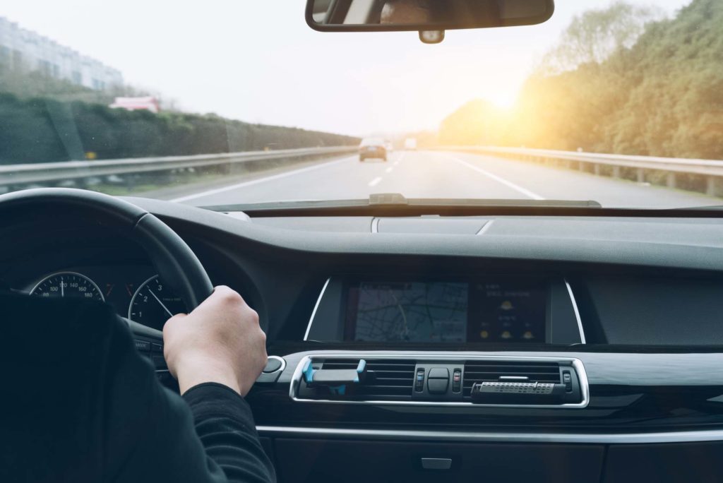 man driving car on a highway