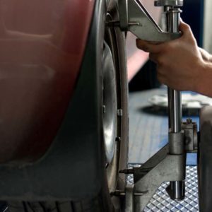 mechanic sets camber caster gauge close look