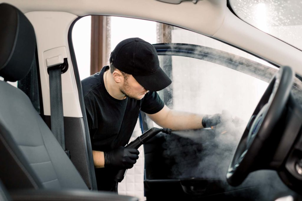 cleaning car with steam cleaner