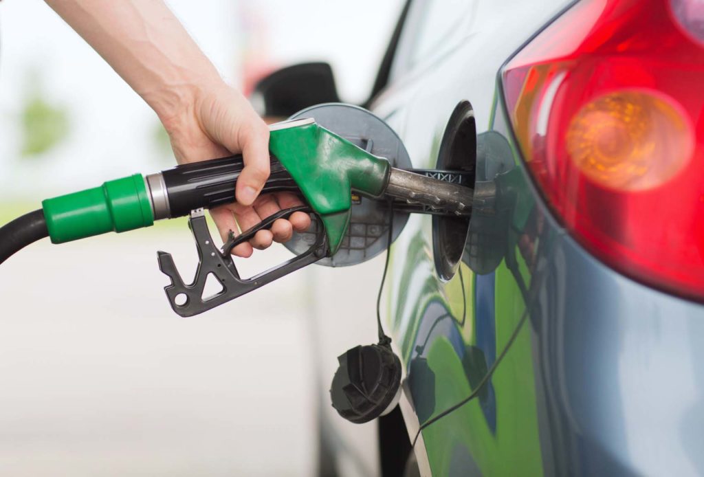 man pumping gasoline fuel to fuel tank