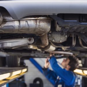 Exhaust of a car on the repair shop bridge