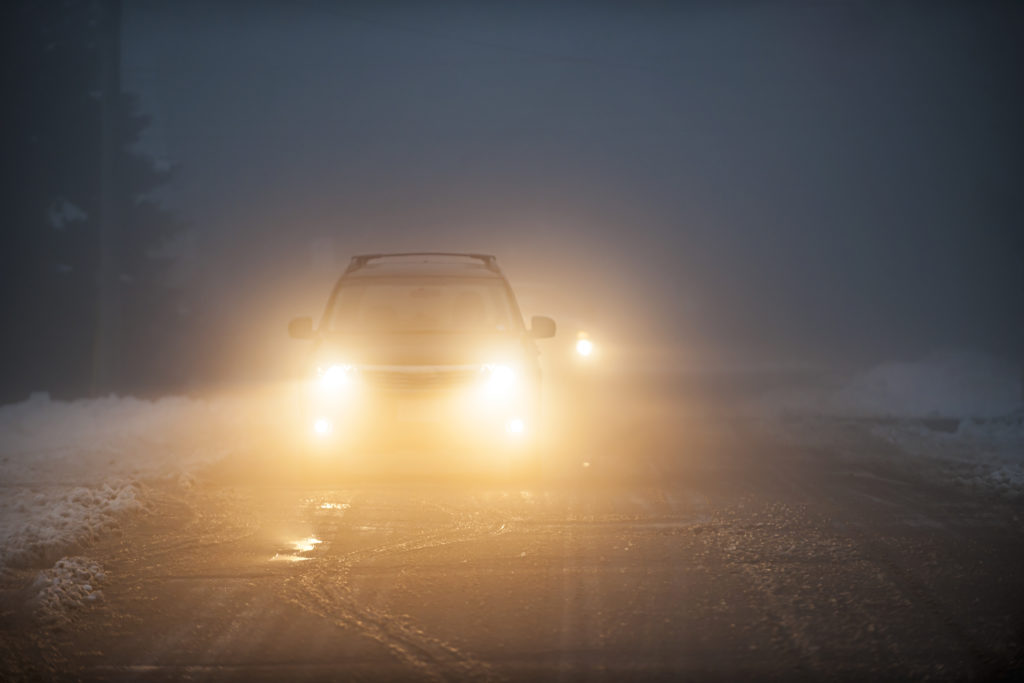 car headlights shining bright through fog.jpg