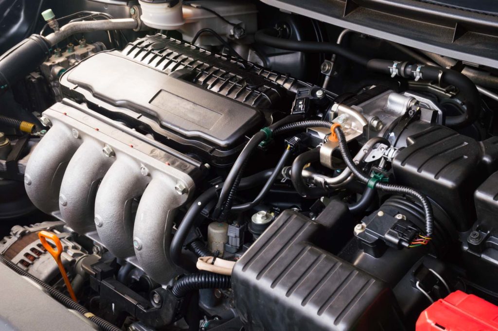 car hood showing various car parts including control modules