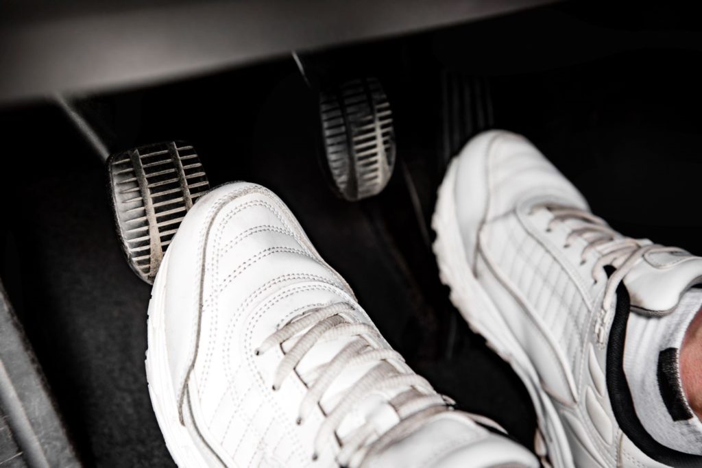 foot pressing the clutch pedal