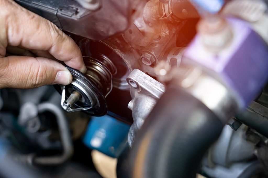 automotive faulty thermostat part being inspected