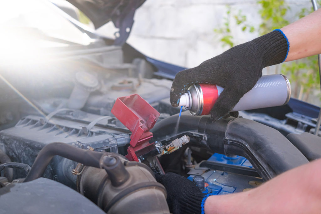 spraying car battery grease