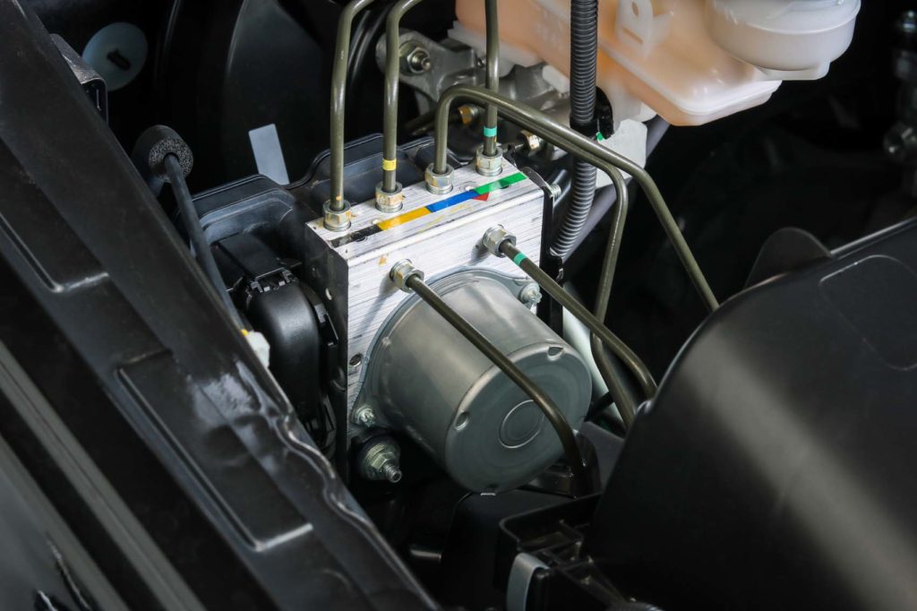 automotive ABS Control Module in engine area focused