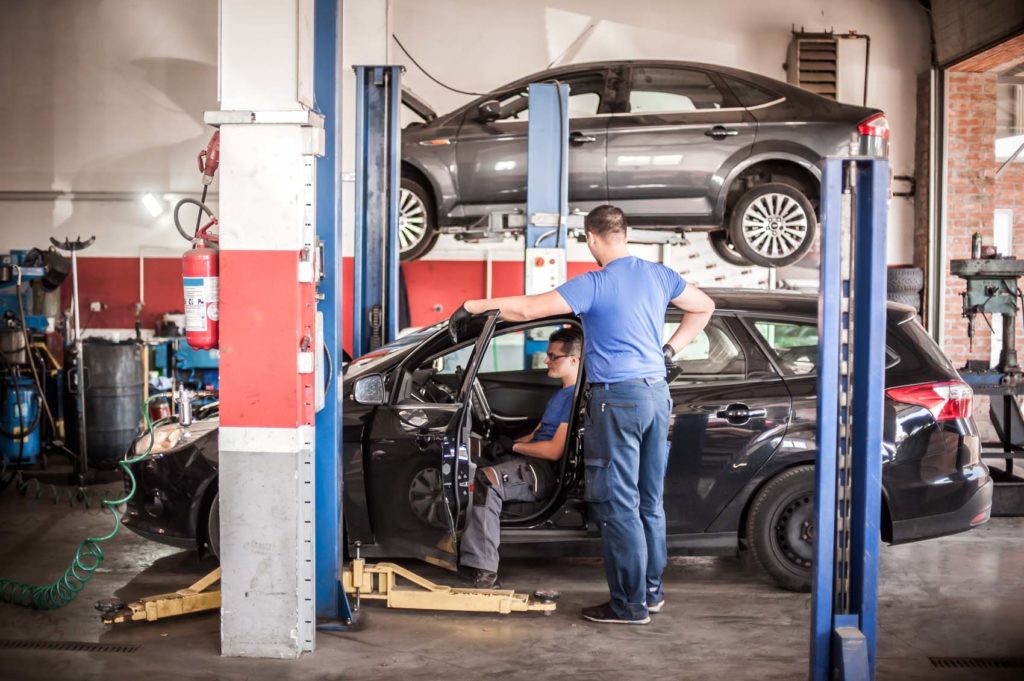 two professional mechanics checks car for P0144 code