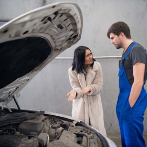 female car owner complaining to mechanic