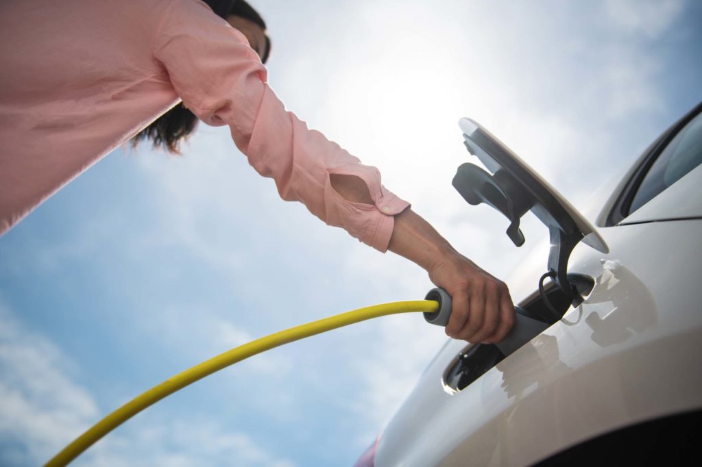 female ev owner charging her car