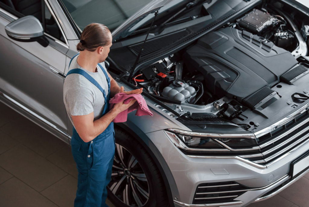 mechanic looking at car engine bay