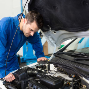 mechanic looks for fuel injector control module