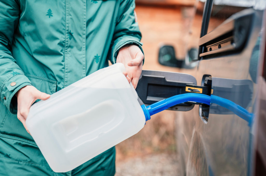 filling a diesel engine ad blue fluid from canister