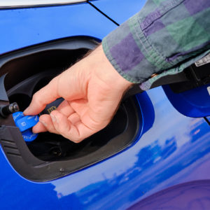 man checking car def cap