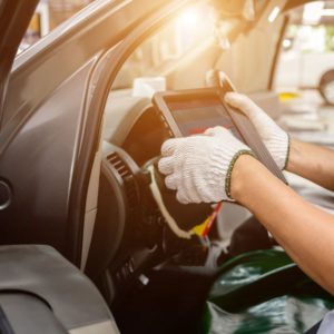 mechanic and a car diagnostic tablet