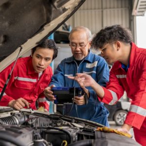 mechanics checking car engine